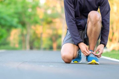 man tying shoes