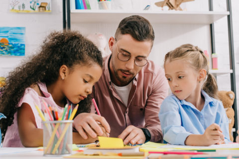 teacher helping students