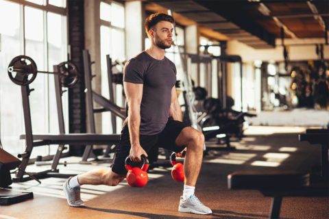 man using kettlebells