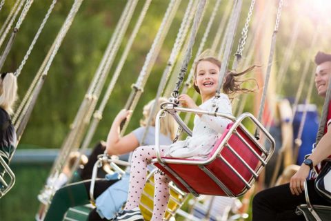 girl on swings at fair