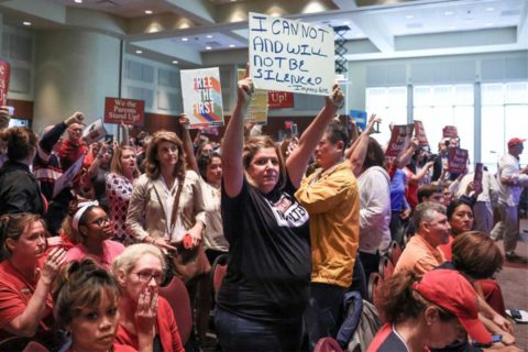 woman protesting at loudoun school board meeting