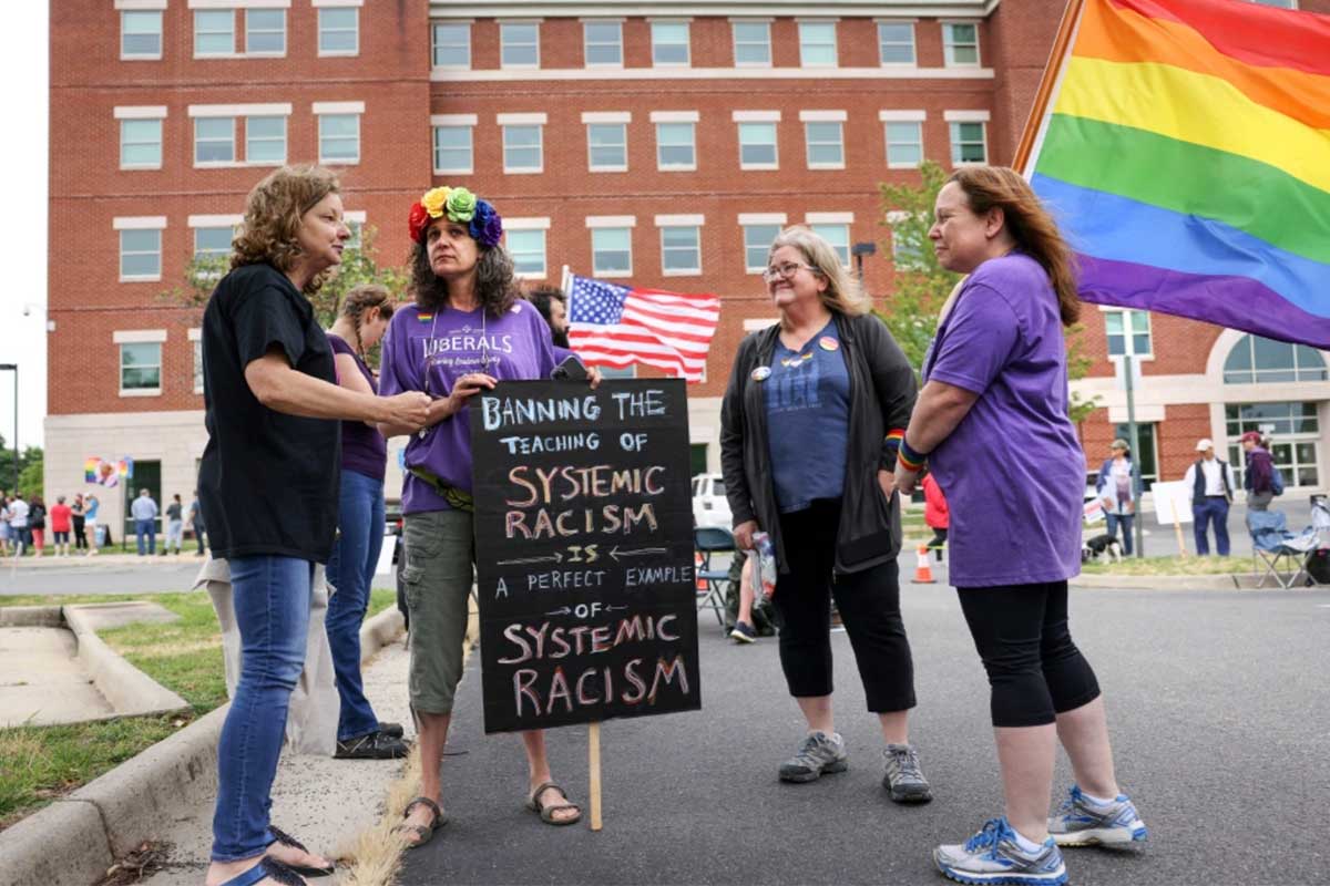 women protesting with rainbow flag