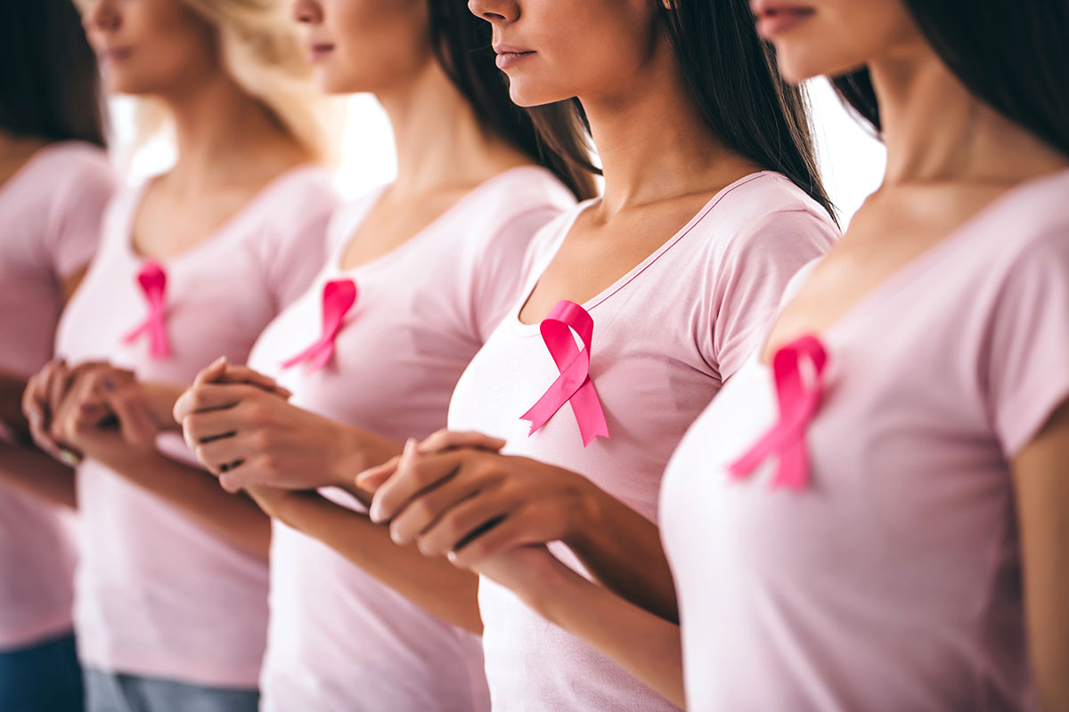 women wearing breast cancer ribbons