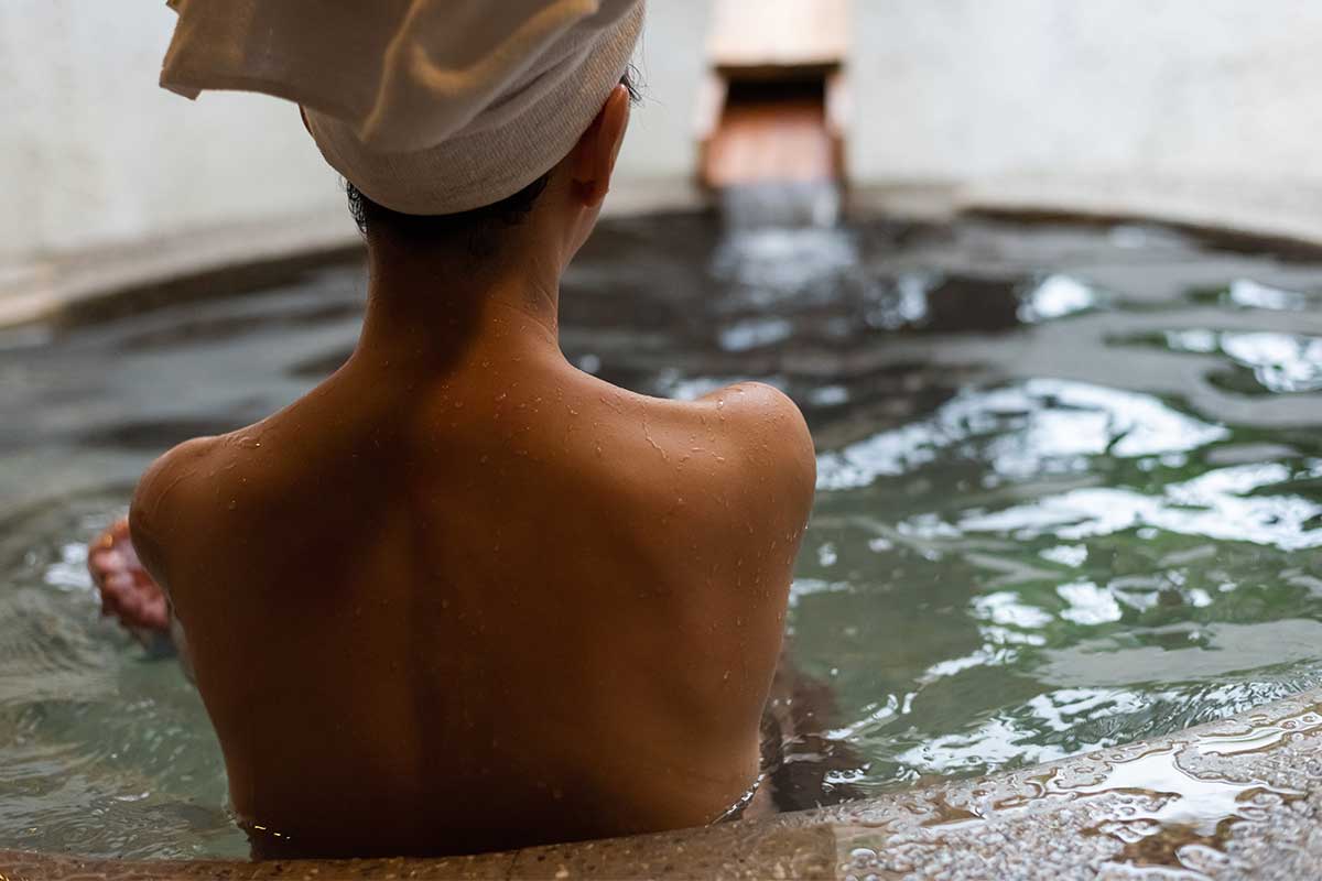 person sitting in water at spa