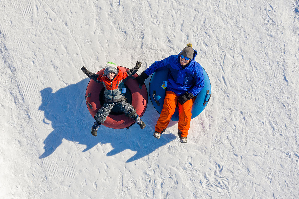 two people snow tubing