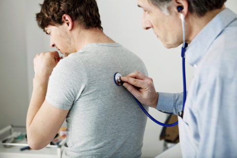 doctor checking patient lungs