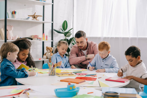 teacher working with students