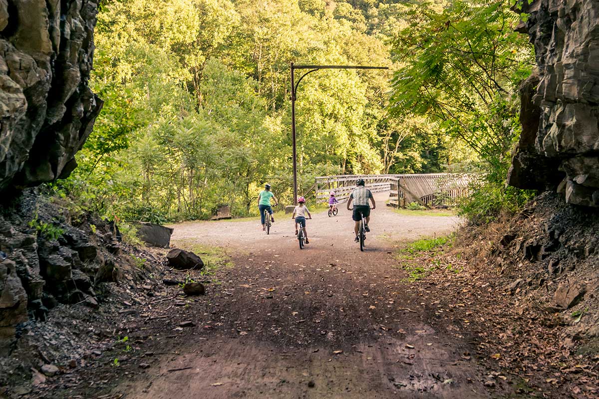 family riding bikes on trail
