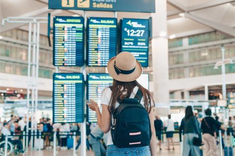 girl looking at plane schedule