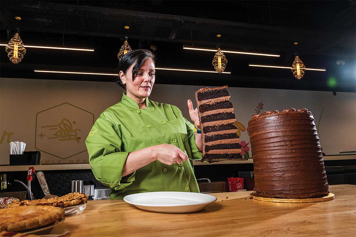 chef holding seven layer cake