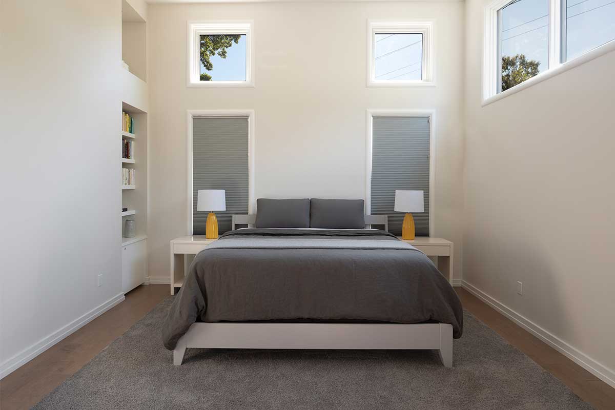 white bedroom with grey bedding