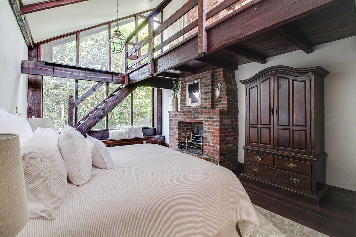 bedroom with large windows and loft