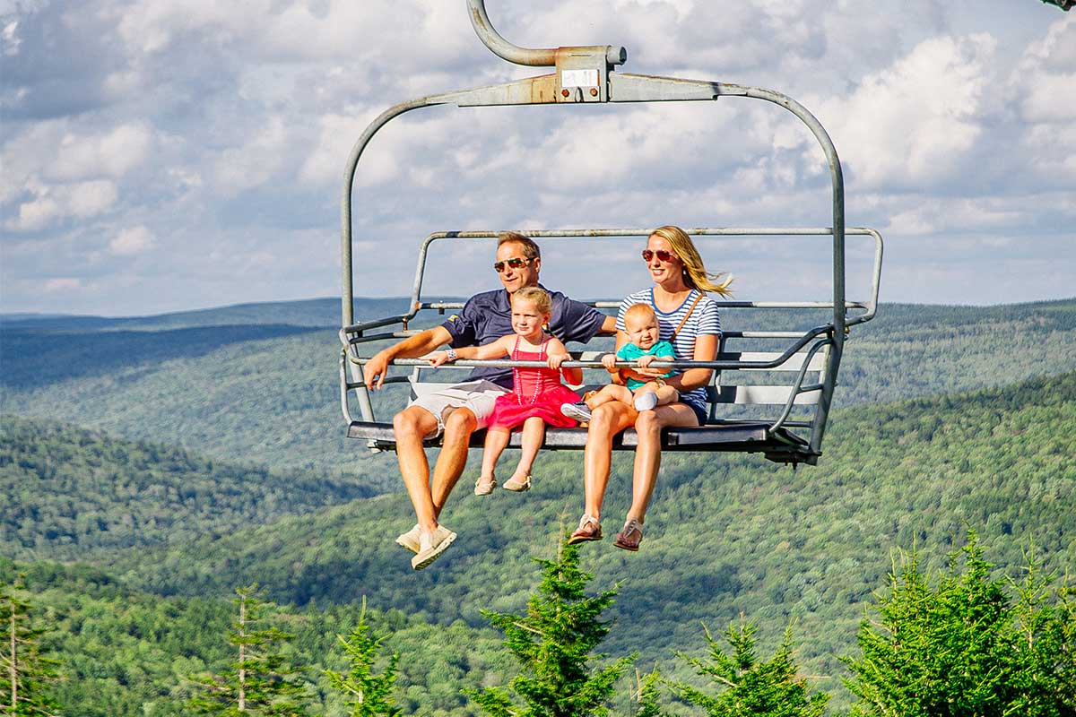 family on chairlift in summer