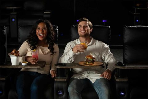couple watching movie at cmx theater