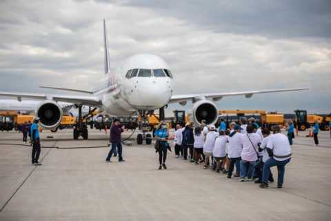people pulling plane