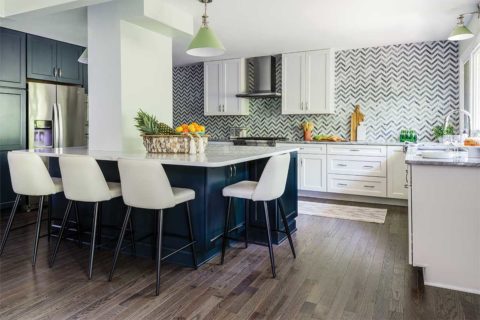 white kitchen with chevron tiles and wood floor