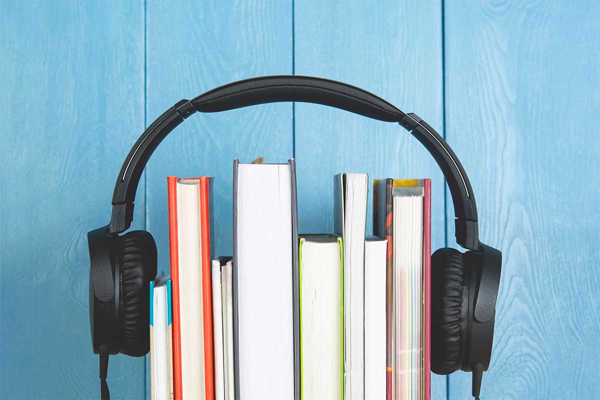 stack of book with headphones