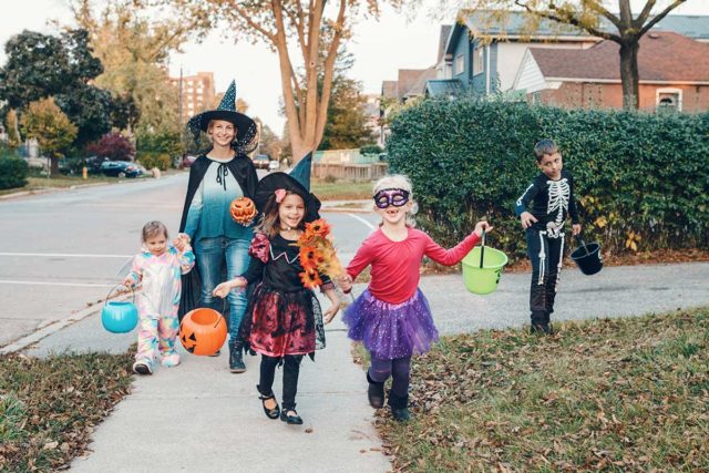 family trick-or-treating on halloween