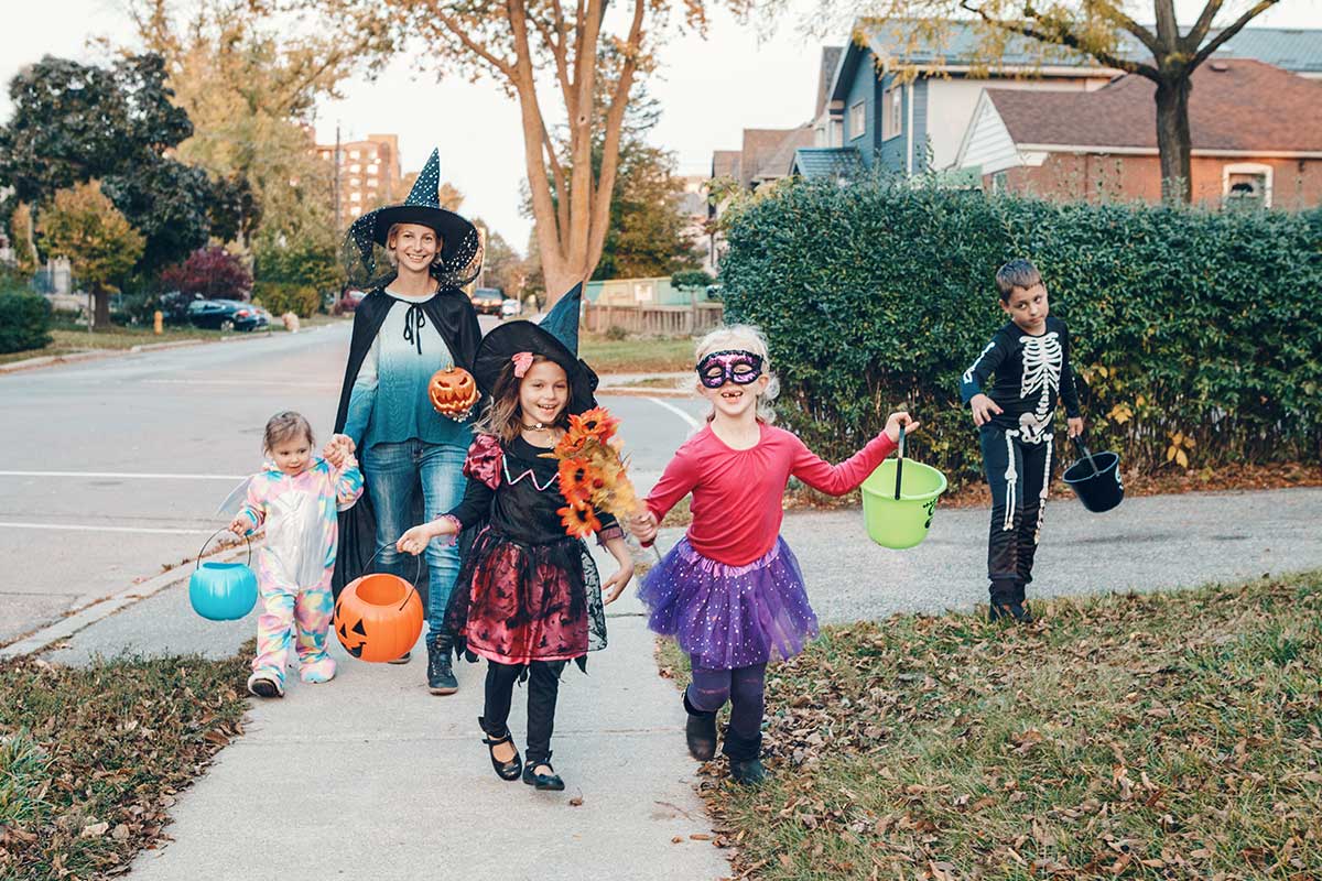 family trick-or-treating on halloween
