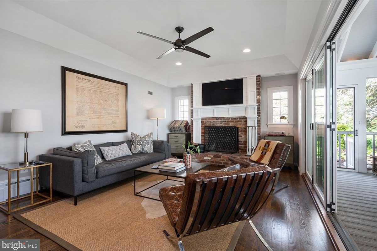 living room with hardwood floors and brick fireplace