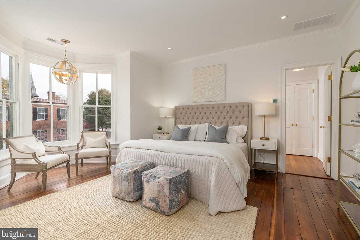 white bedroom with hardwood floors