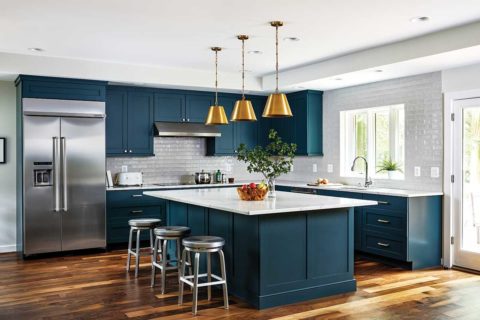 white tile kitchen with dark blue cabinets