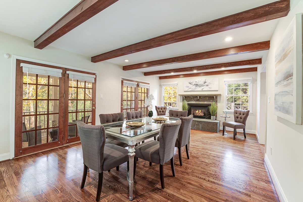 dining room with exposed beams and wood floors