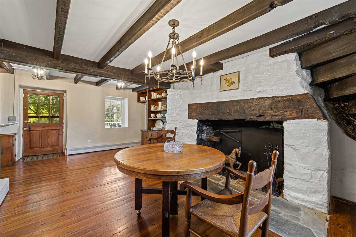 entryway with fireplace and exposed beams