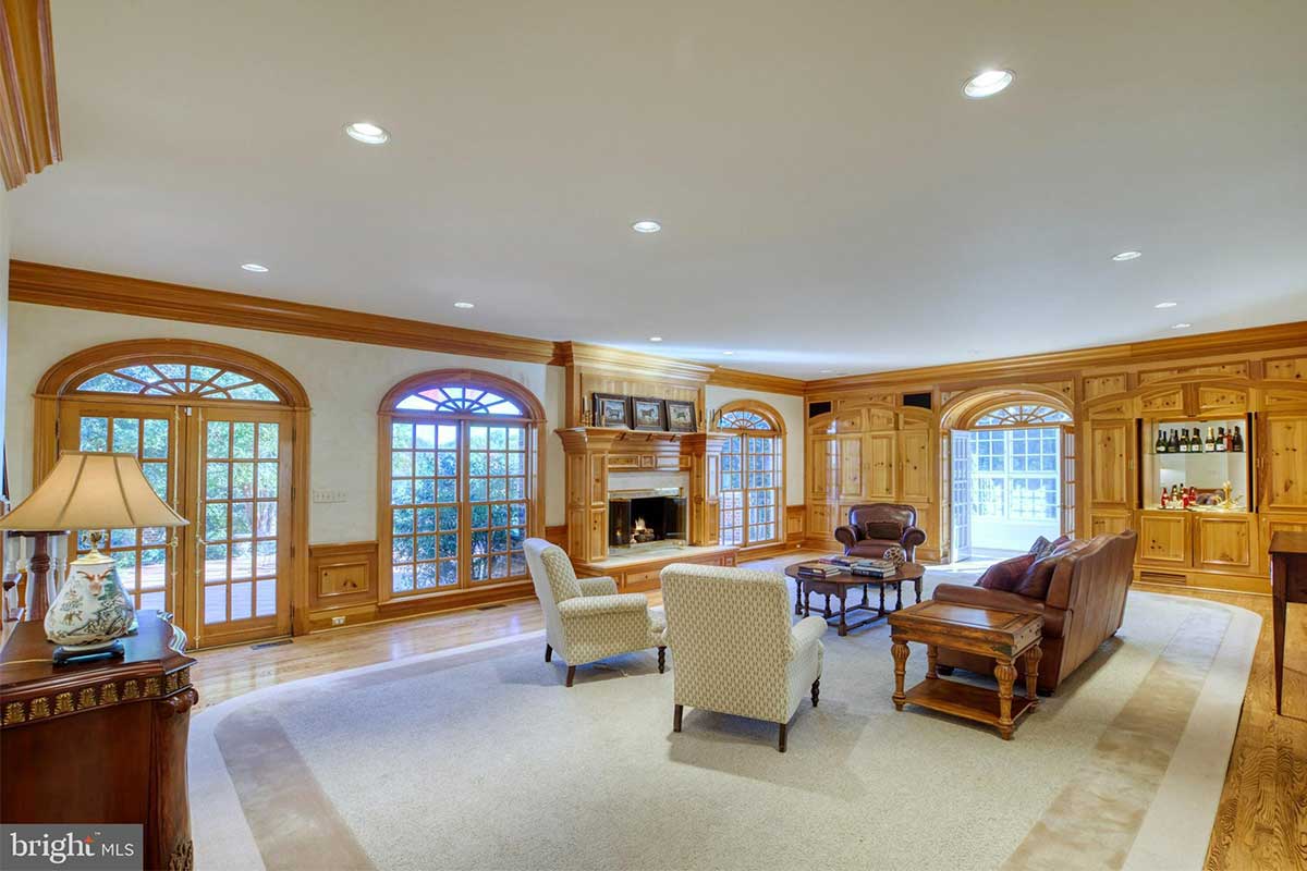 family room with wood paneling and fireplace