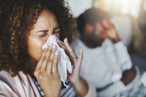woman blowing her nose