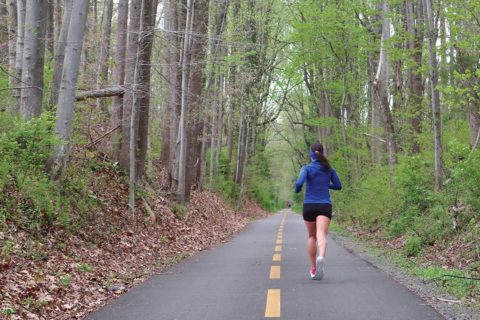 woman running down trail
