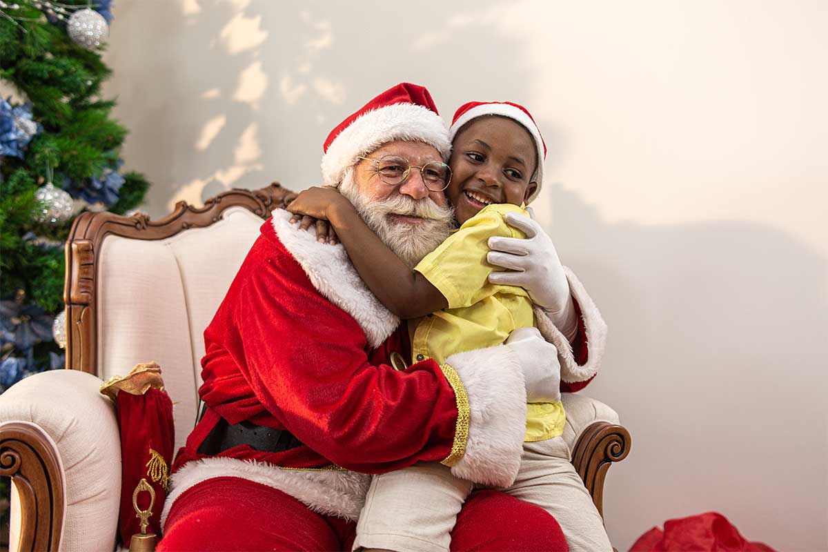 santa posing with picture with boy