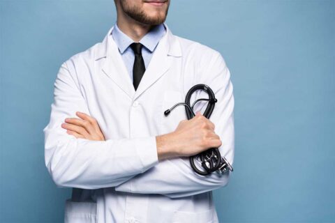 man in white coat holding stethesope