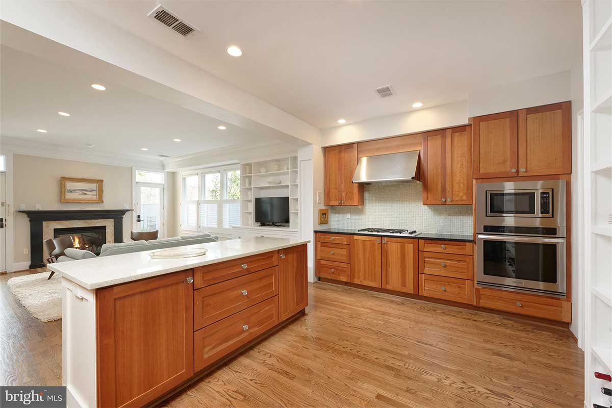 white kitchen with wood cabinets and hardwood floor
