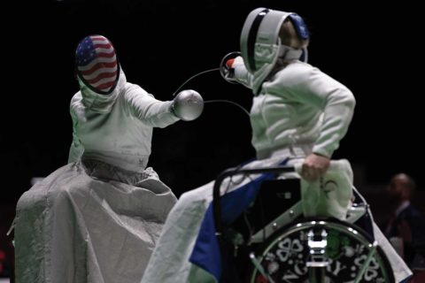 two people wheelchair fencing