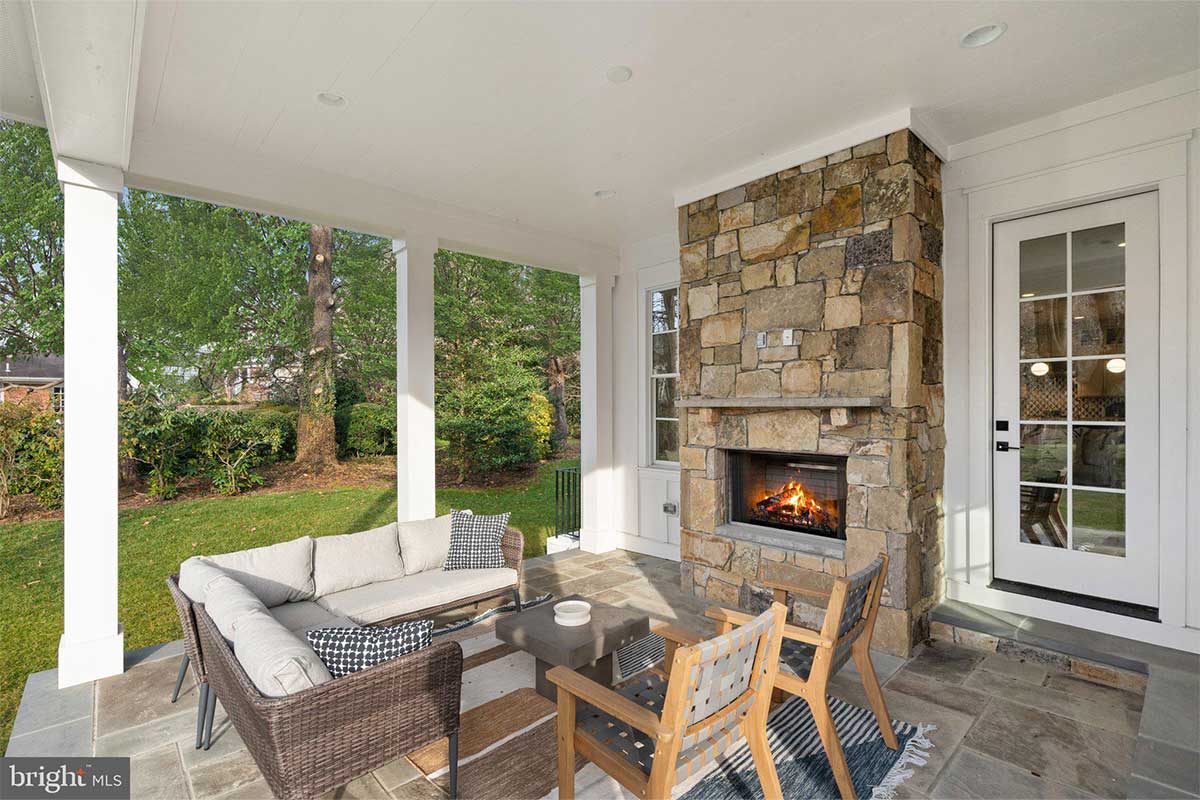outdoor stone fireplace on back patio
