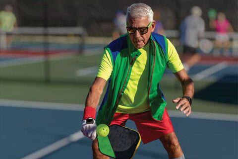 senior playing pickleball