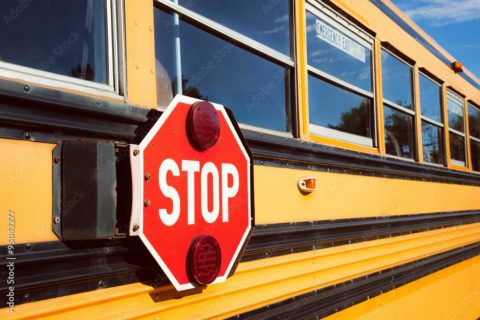school bus with stop on its side