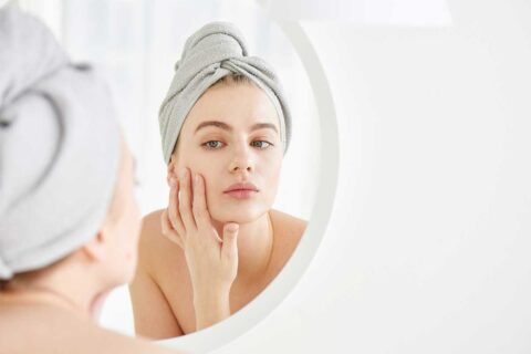 woman looking in mirror