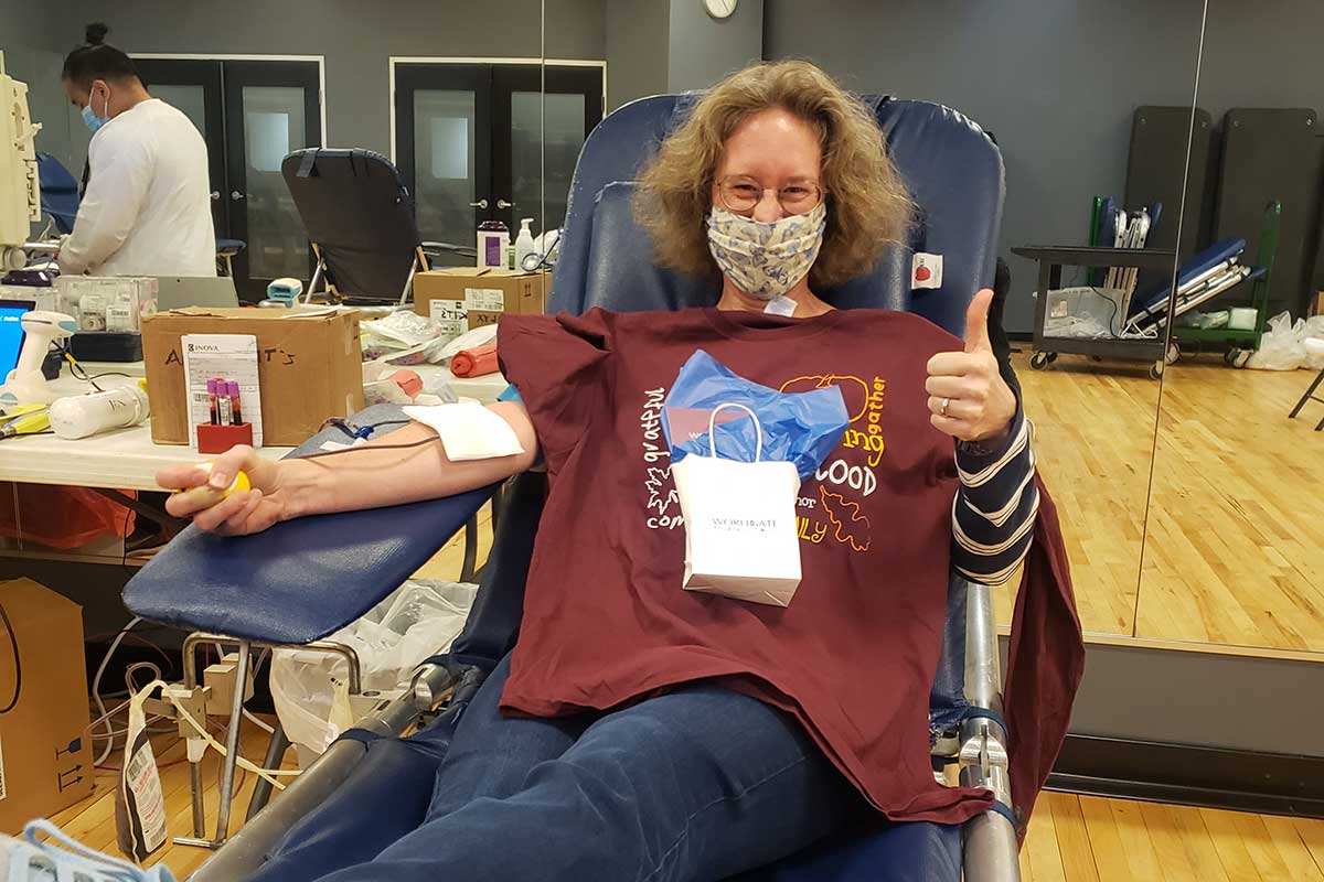 woman gives blood at Inova drive