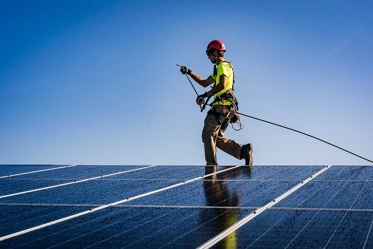 Secure Solar worker works on an installation of solar panels.
