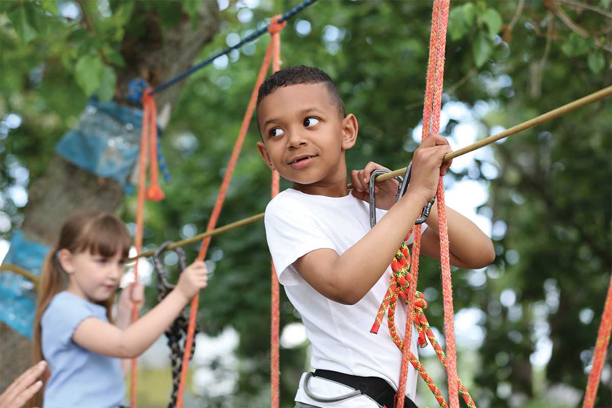 child on ropes course, often an activity at summer camps
