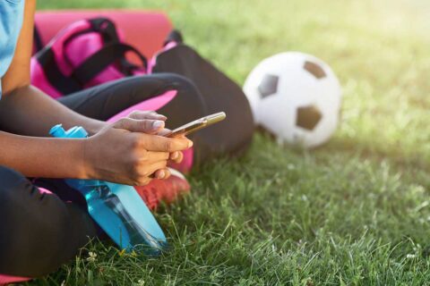 person with water bottle next to soccer bowl