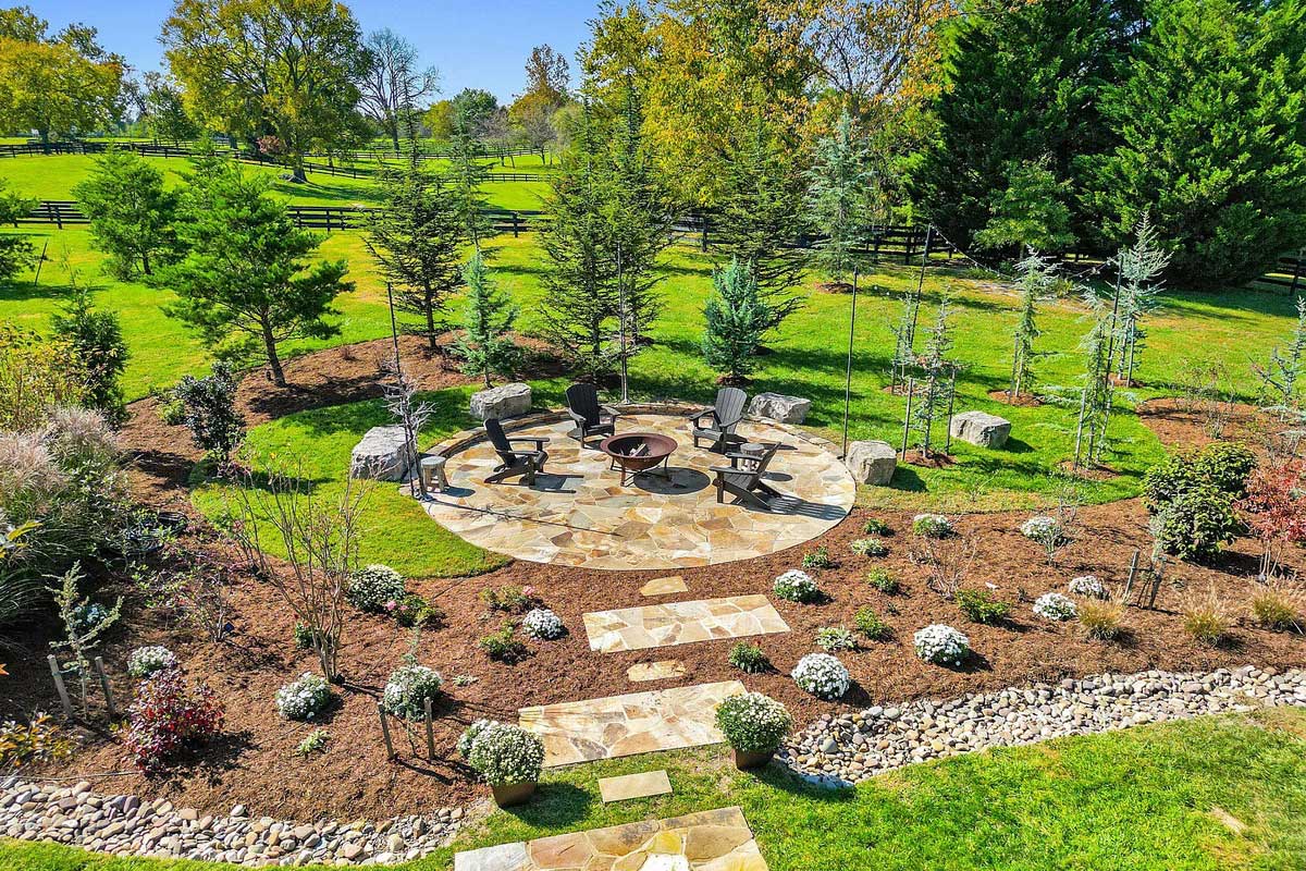 landscaped yard with firepit