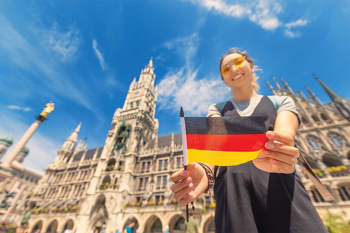 woman holding germany flag in front of building