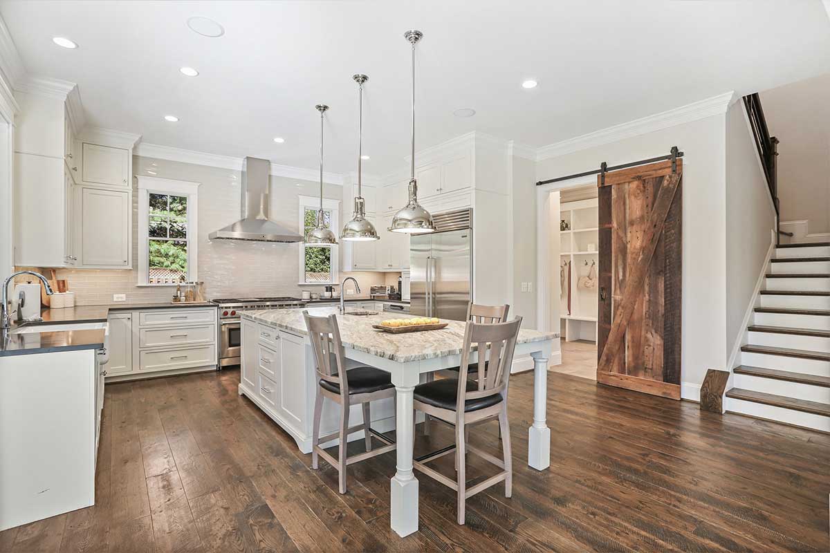 white kitchen with wood floors and island