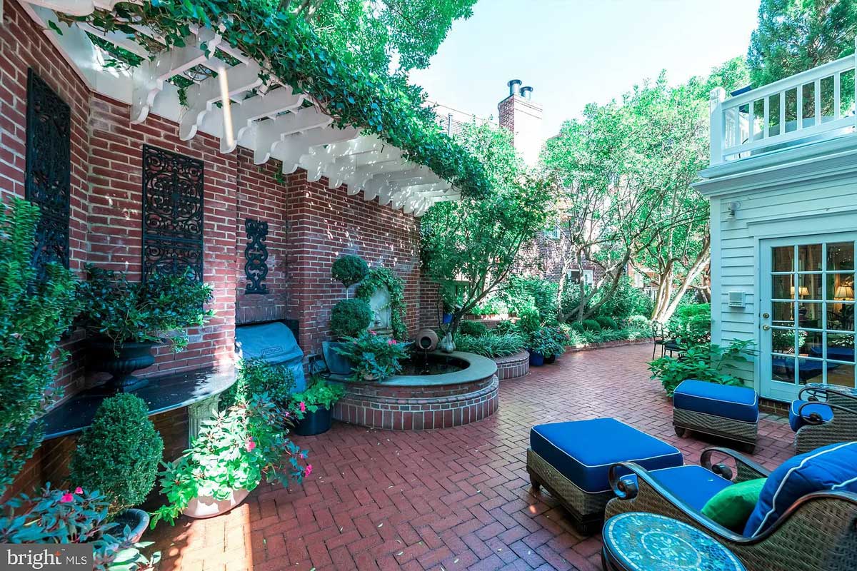 Old Town home brick patio with trellis and pond