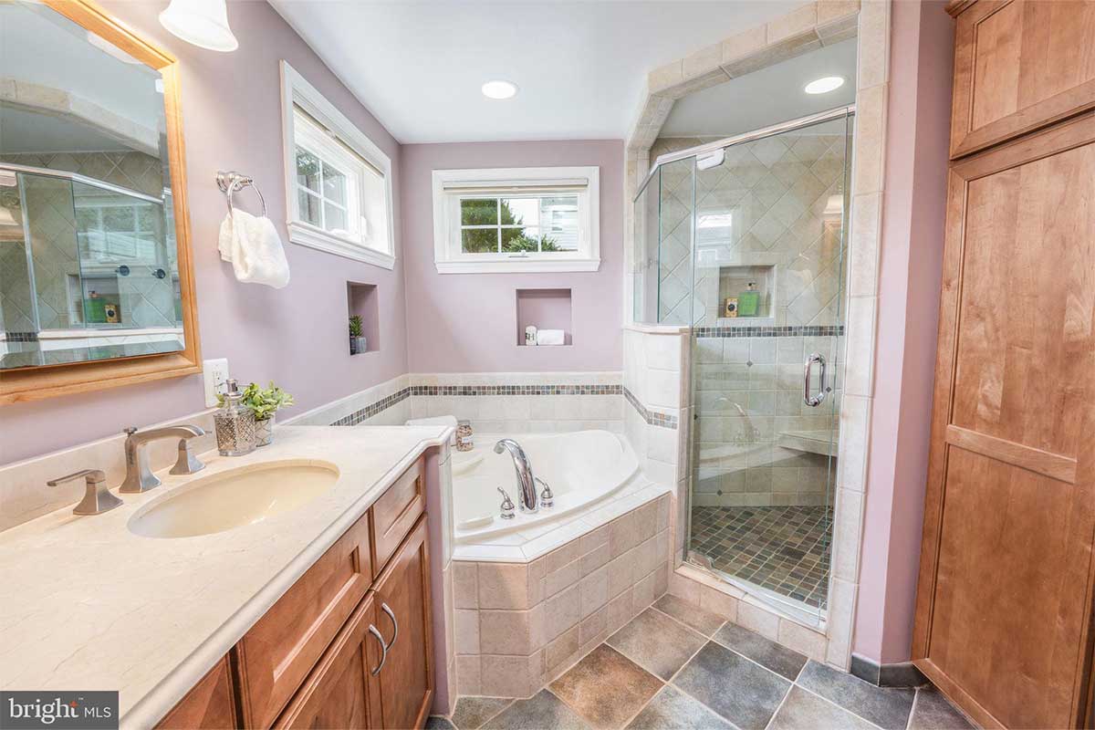 purple bathrrom with tub and shower