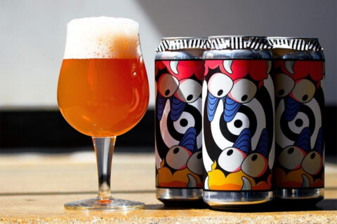 glass of beer with aslin beer cans