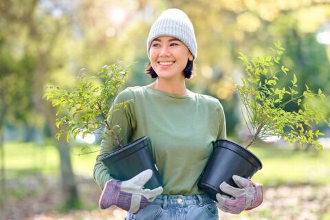 woman holding trees